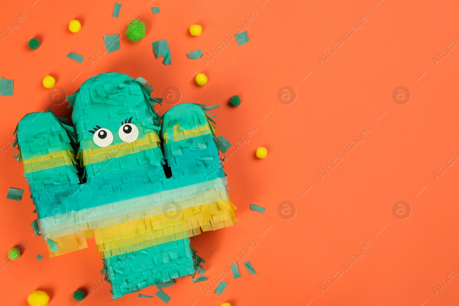 Photo of Bright cactus pinata and confetti on orange background, flat lay. Space for text