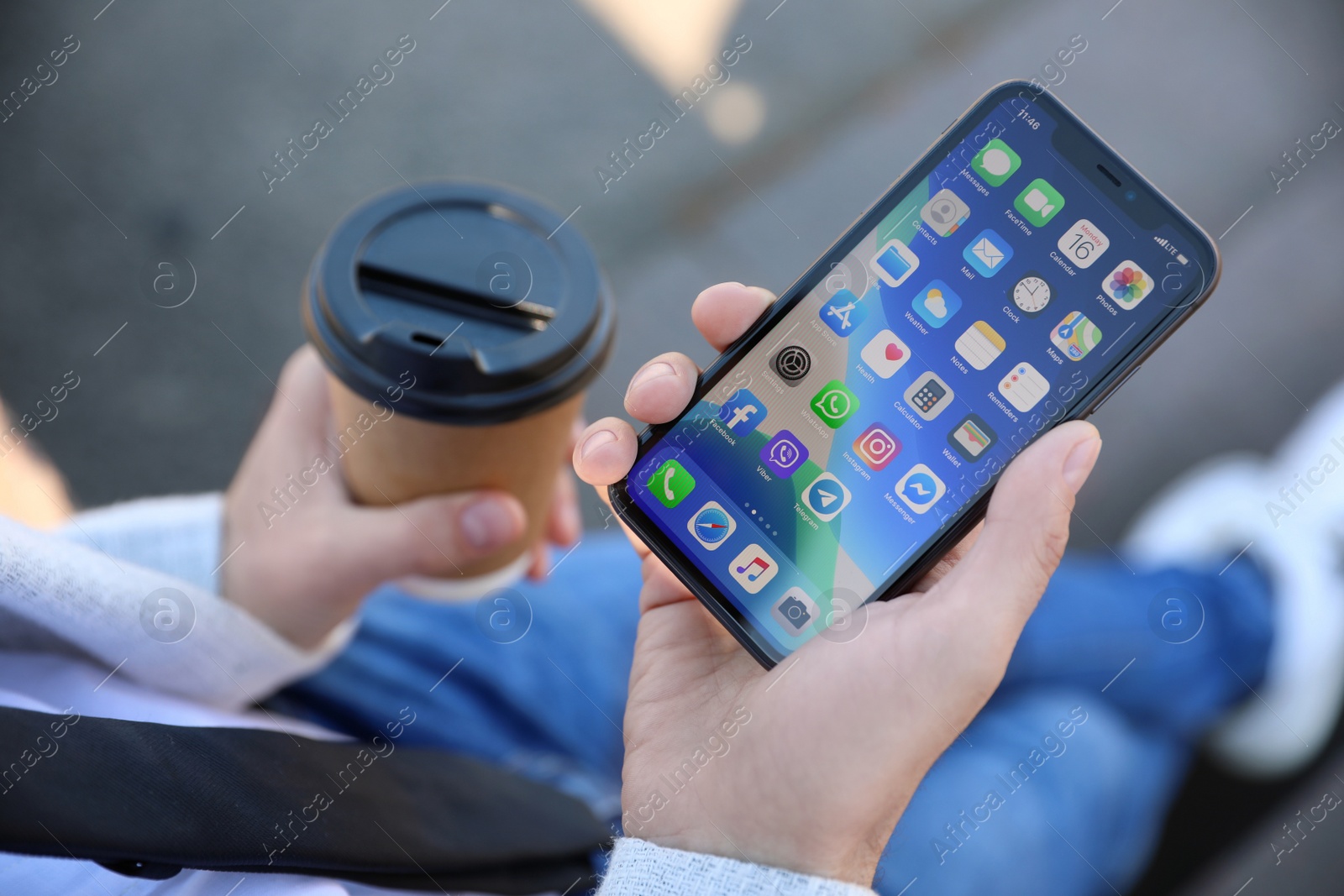 Photo of MYKOLAIV, UKRAINE - MARCH 16, 2020: Man holding iPhone 11 with home screen outdoors, closeup