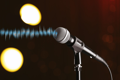 Microphone and radio wave on dark background, bokeh effect