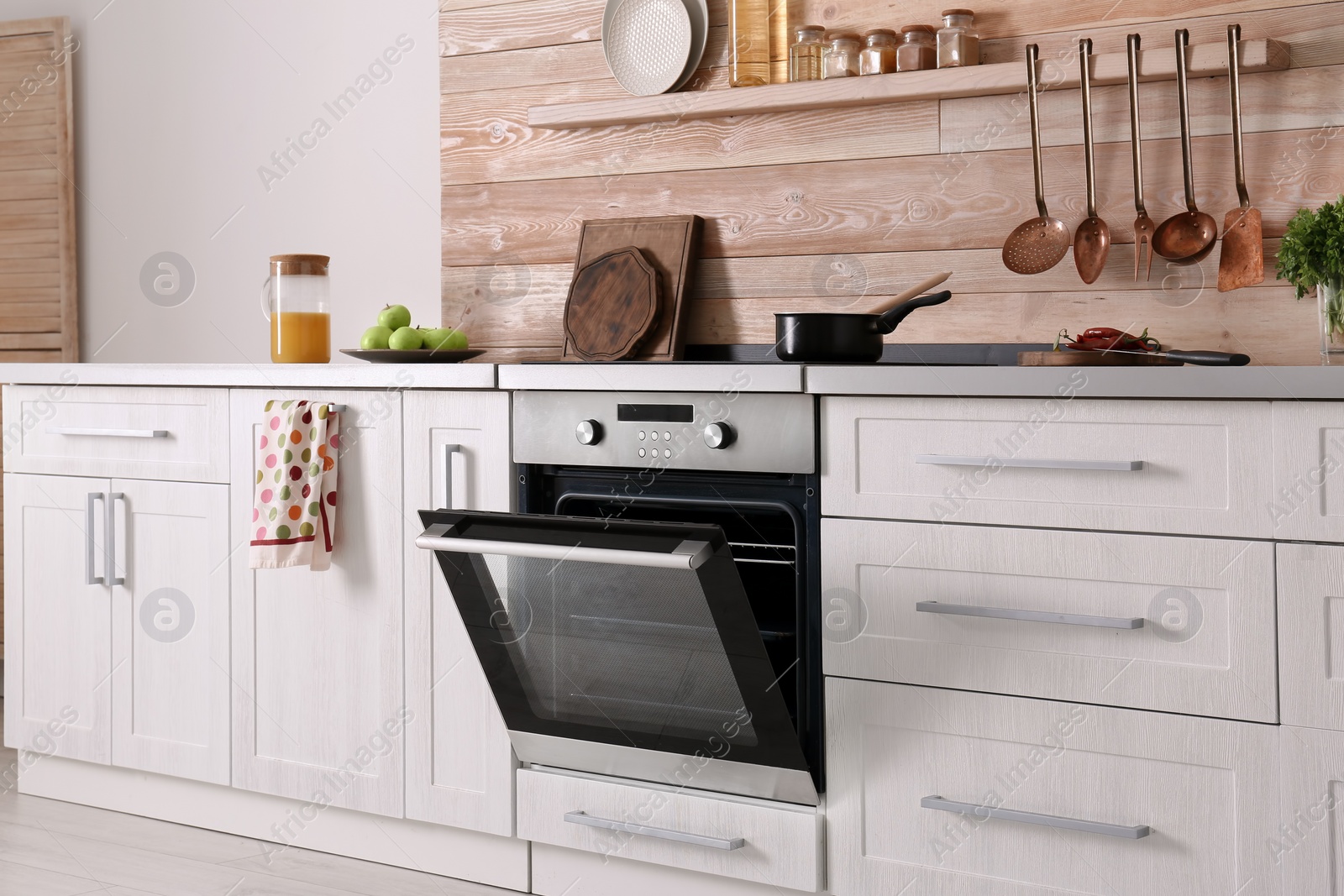 Photo of Light modern kitchen interior with new oven