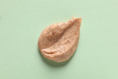 Photo of Sample of scrub on light green background, top view