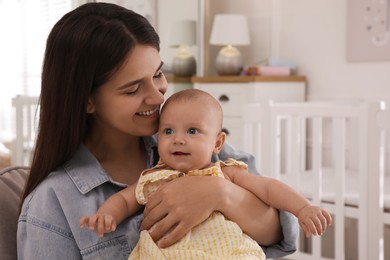 Photo of Happy young mother with her cute baby at home