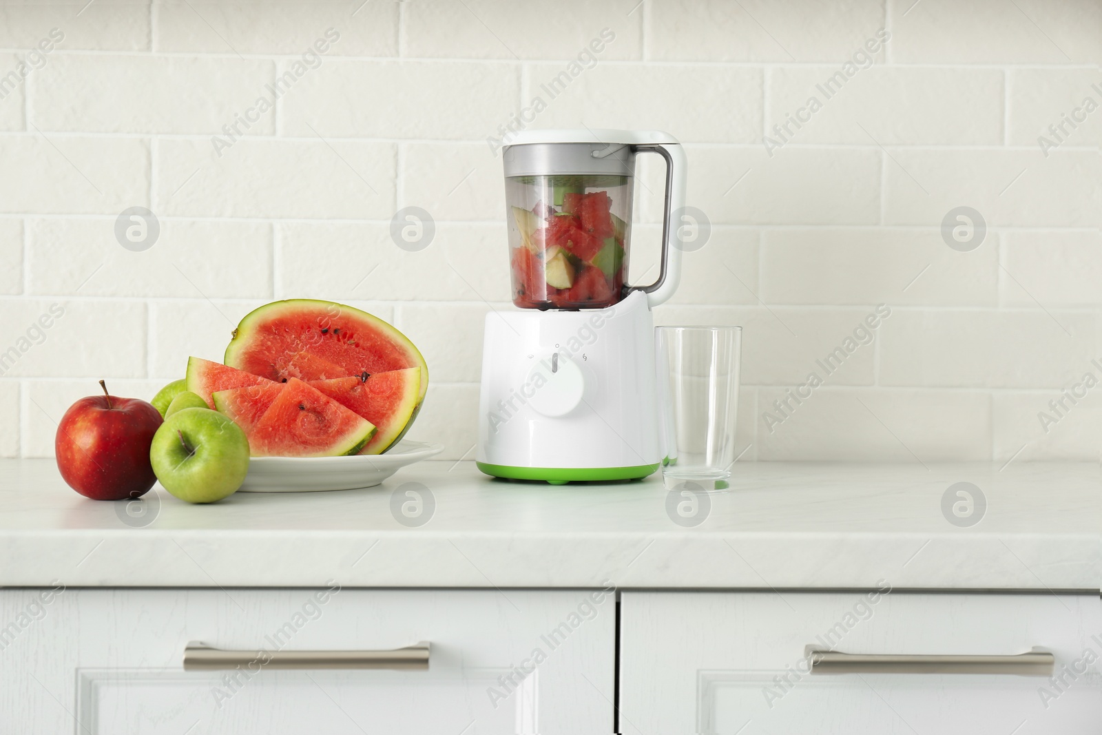 Photo of Blender and smoothie ingredients on counter in kitchen