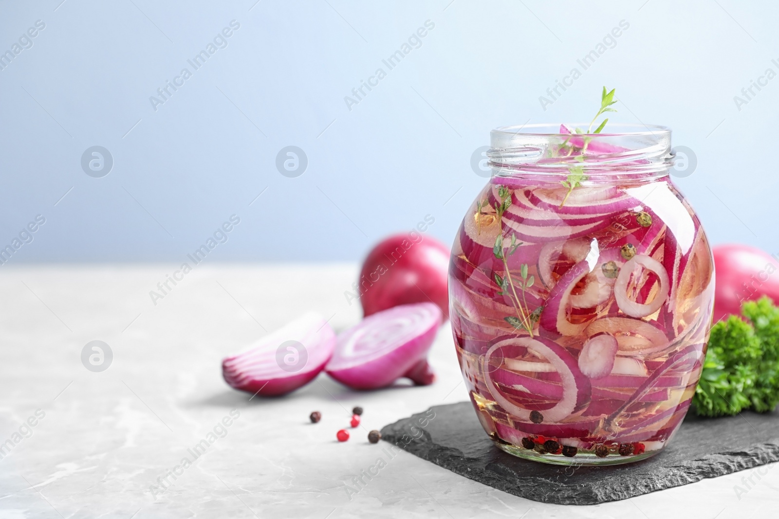 Photo of Jar of pickled onions on table, space for text