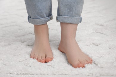 Photo of Woman standing on beige carpet, closeup view