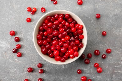 Photo of Fresh ripe cranberries in bowl on grey table, top view