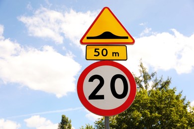 Post with different road signs against sky