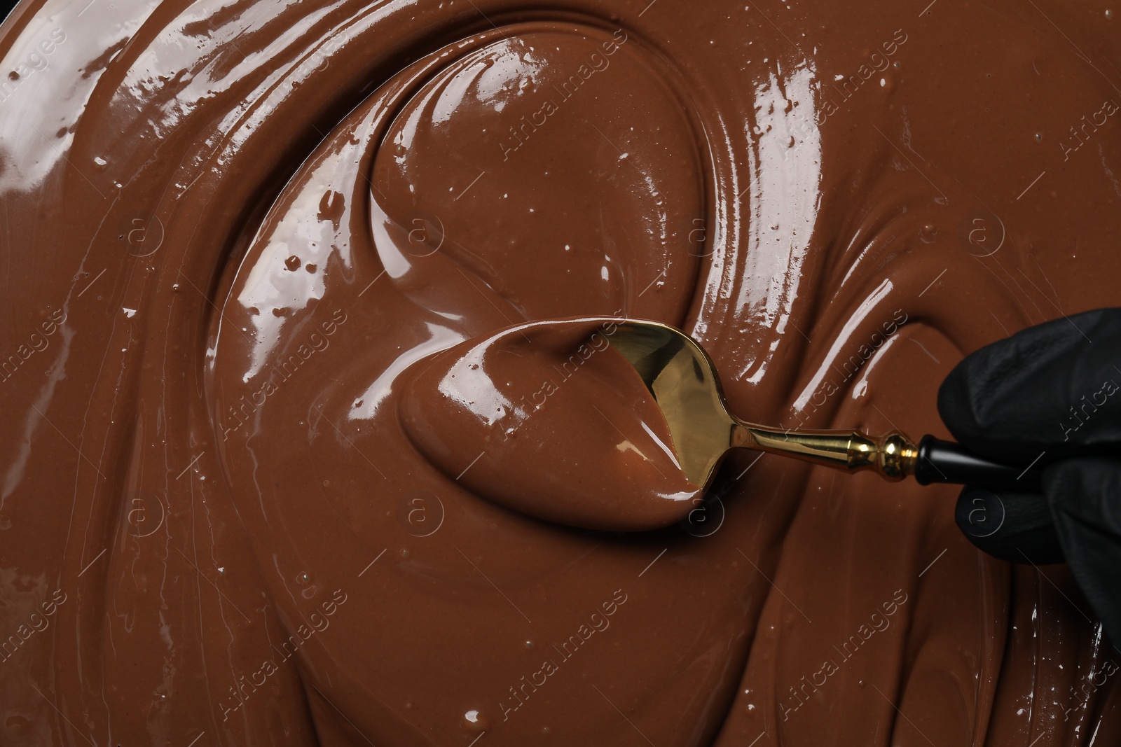 Photo of Person making tasty milk chocolate paste, top view