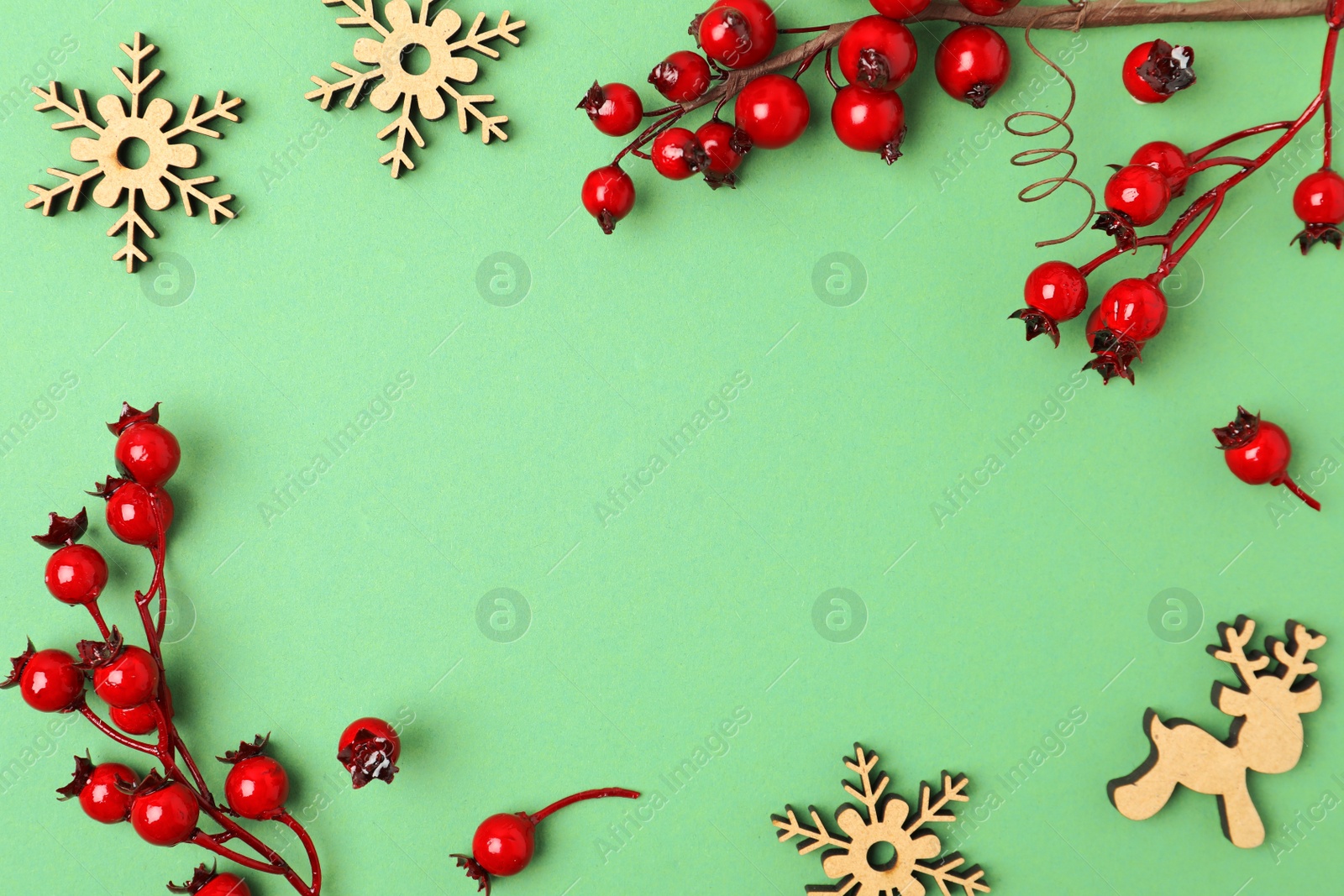 Photo of Winter composition with decorative branches on green background, flat lay. Space for text