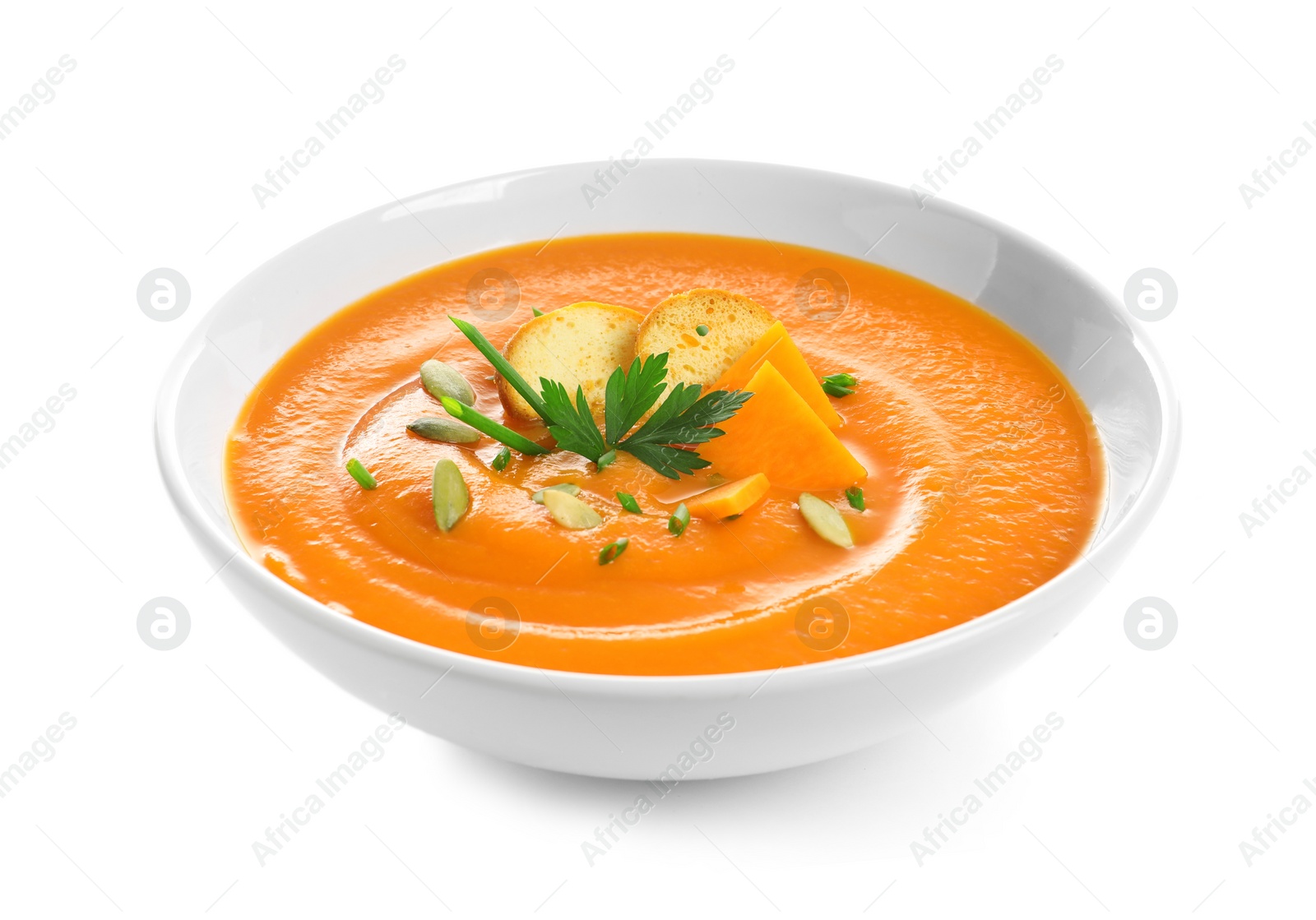 Photo of Dish with pumpkin cream soup on white background. Healthy food