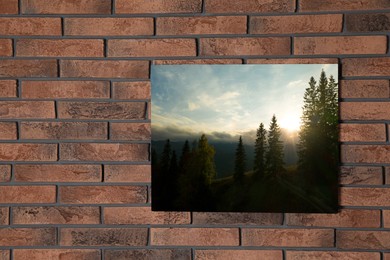 Image of Canvas with printed photo of forest and mountain landscape on brick wall, space for text