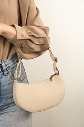 Photo of Woman with stylish baguette handbag on white background, closeup