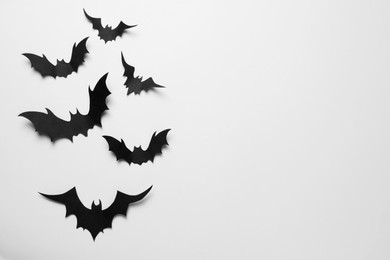 Photo of Many paper bats on white background, flat lay with space for text. Halloween celebration