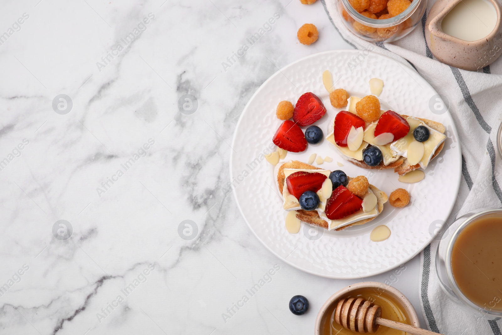 Photo of Tasty brie cheese sandwiches on white marble table, flat lay. Space for text