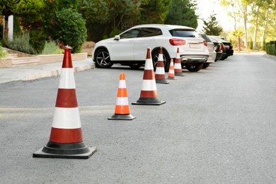 Photo of Traffic cones near cars on asphalt outdoors