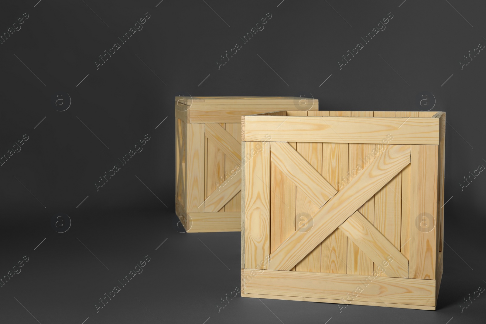 Photo of Wooden crates on dark background, space for text. Shipping containers