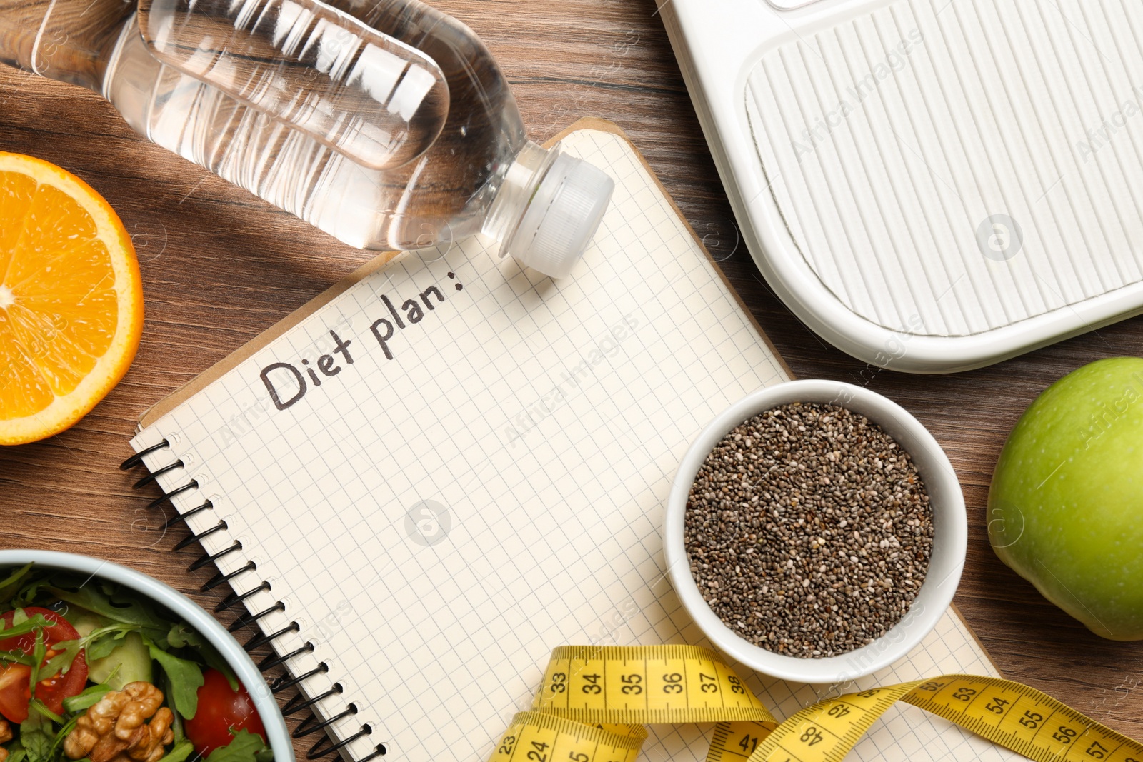 Photo of Weight loss concept. Flat lay composition with notebook, measuring tape and different products on wooden table