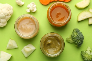 Photo of Jars with healthy baby food, fresh vegetables and fruits on light green background, flat lay