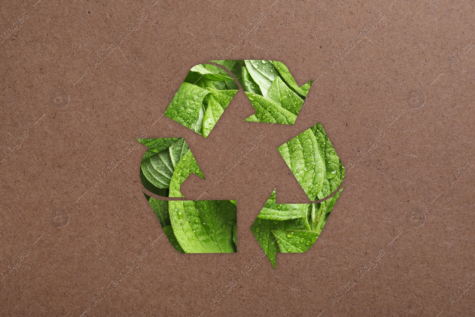 Image of Recycling symbol made of green leaves on kraft paper