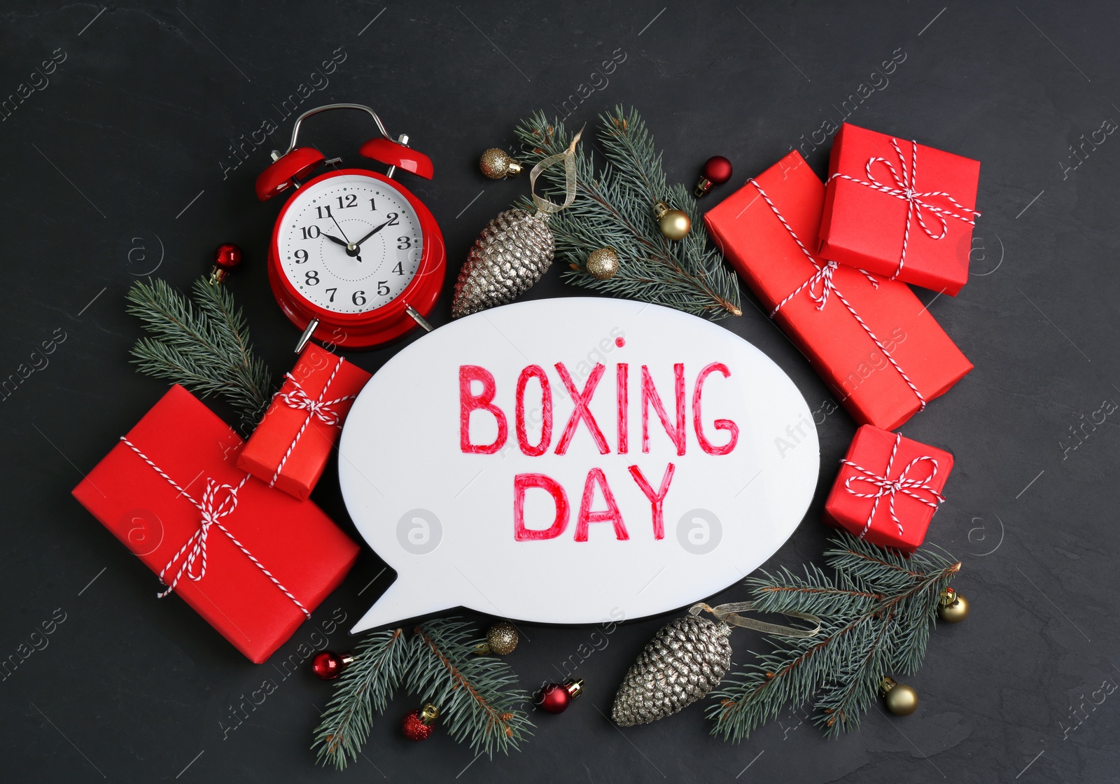 Photo of Flat lay composition with Boxing Day sign and Christmas gifts on black table