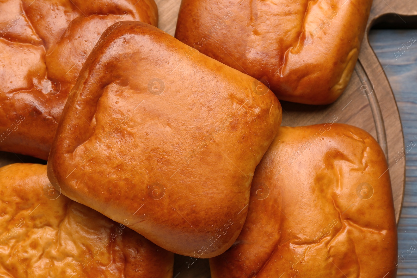 Photo of Many delicious baked patties on table, top view