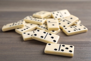 Photo of Pile of domino tiles on wooden table