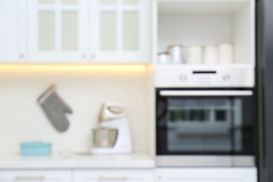 Photo of Blurred view of modern kitchen with appliances