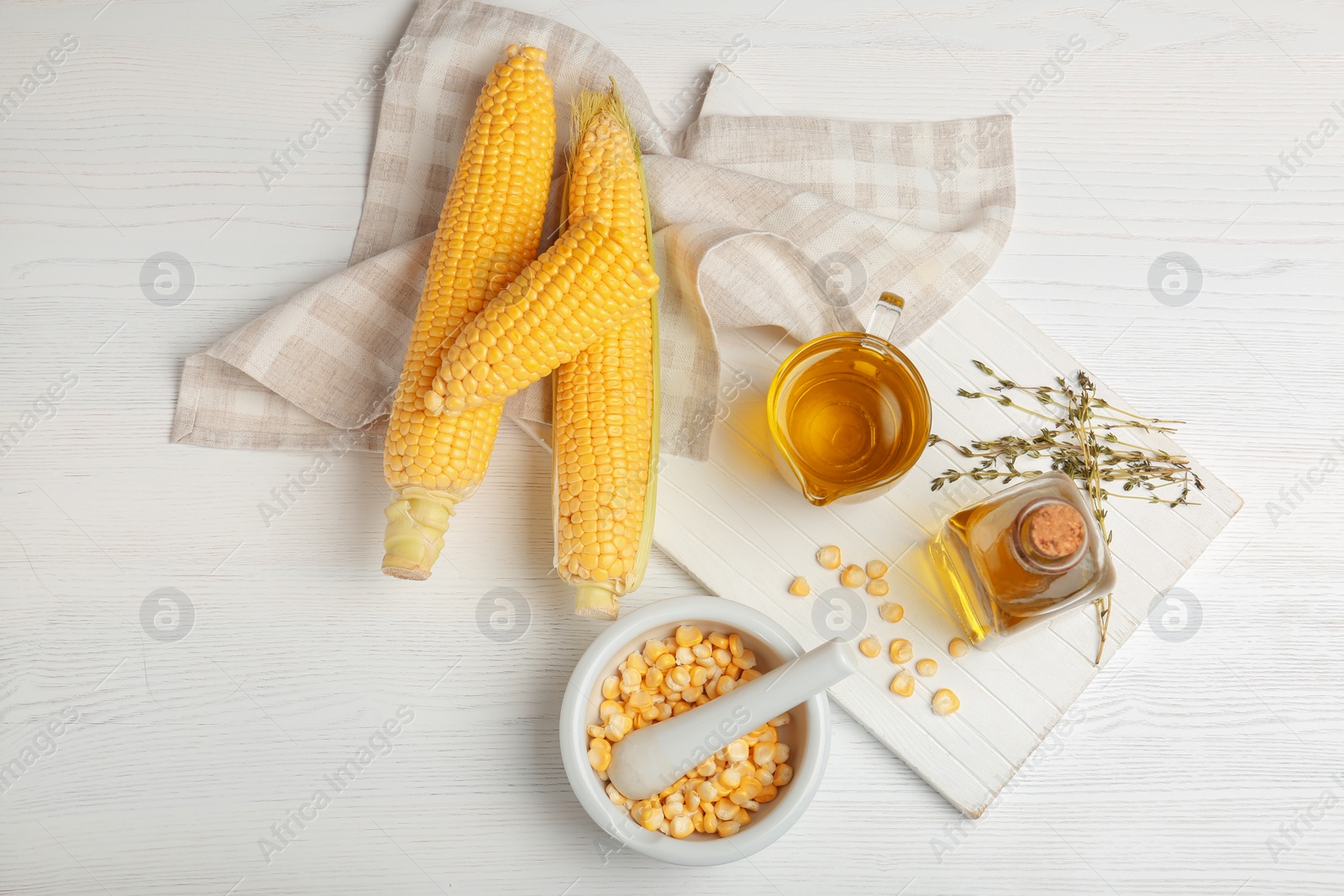 Photo of Flat lay composition with fresh corn oil on wooden table