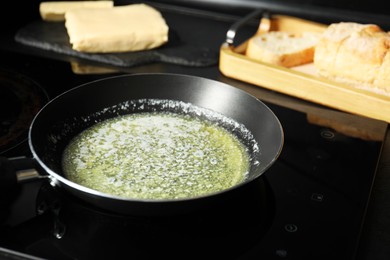 Melting butter in frying pan on cooktop