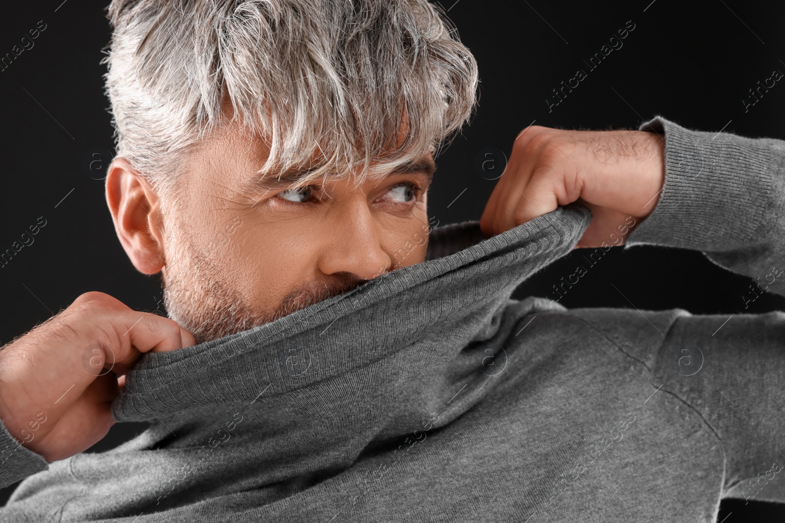 Photo of Portrait of man with beautiful hairstyle on black background