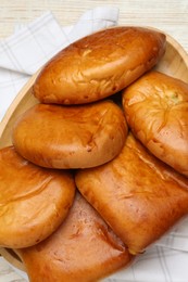 Delicious baked patties on white wooden table, top view