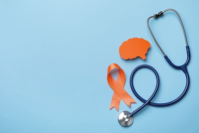 Photo of Orange ribbon, stethoscope and paper brain cutout on light blue background, flat lay with space for text. Multiple sclerosis awareness