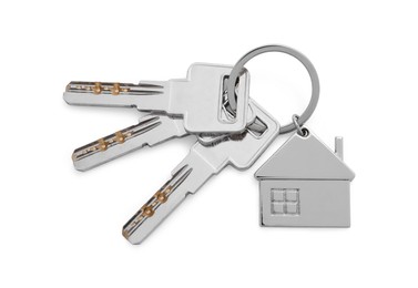 Keys with keychain in shape of house isolated on white, top view