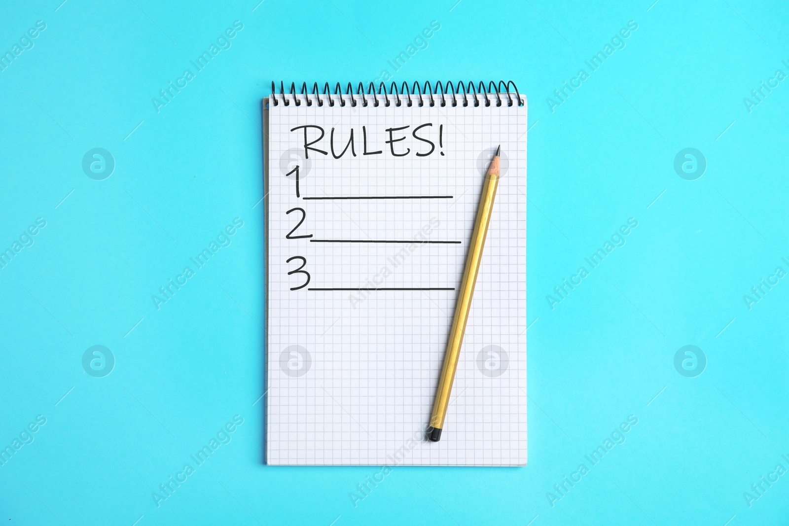 Image of Notepad with list of rules and pencil on light blue background, top view