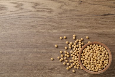 Organic soy beans on wooden table, flat lay. Space for text