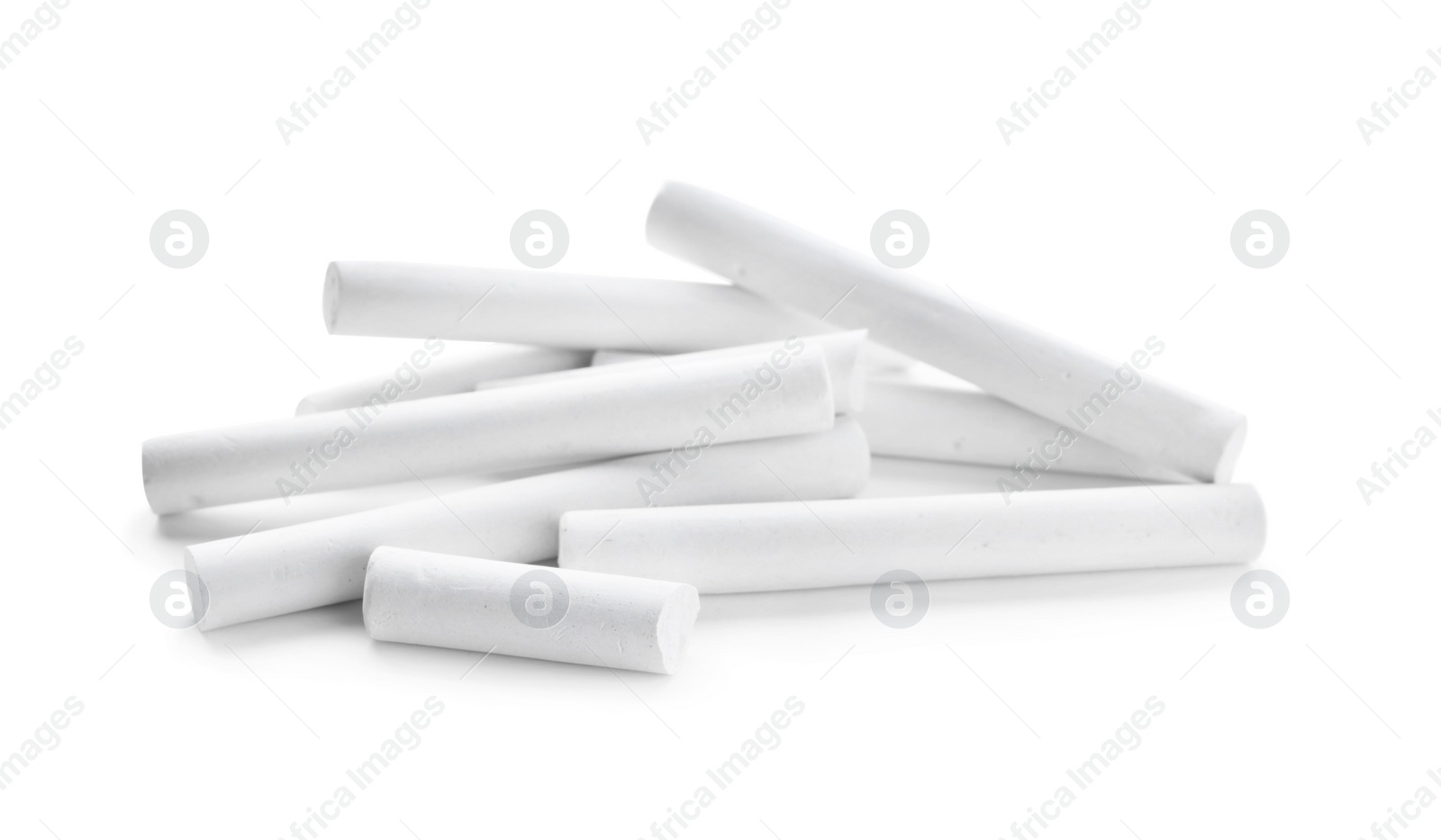 Photo of Small pieces of chalk on white background