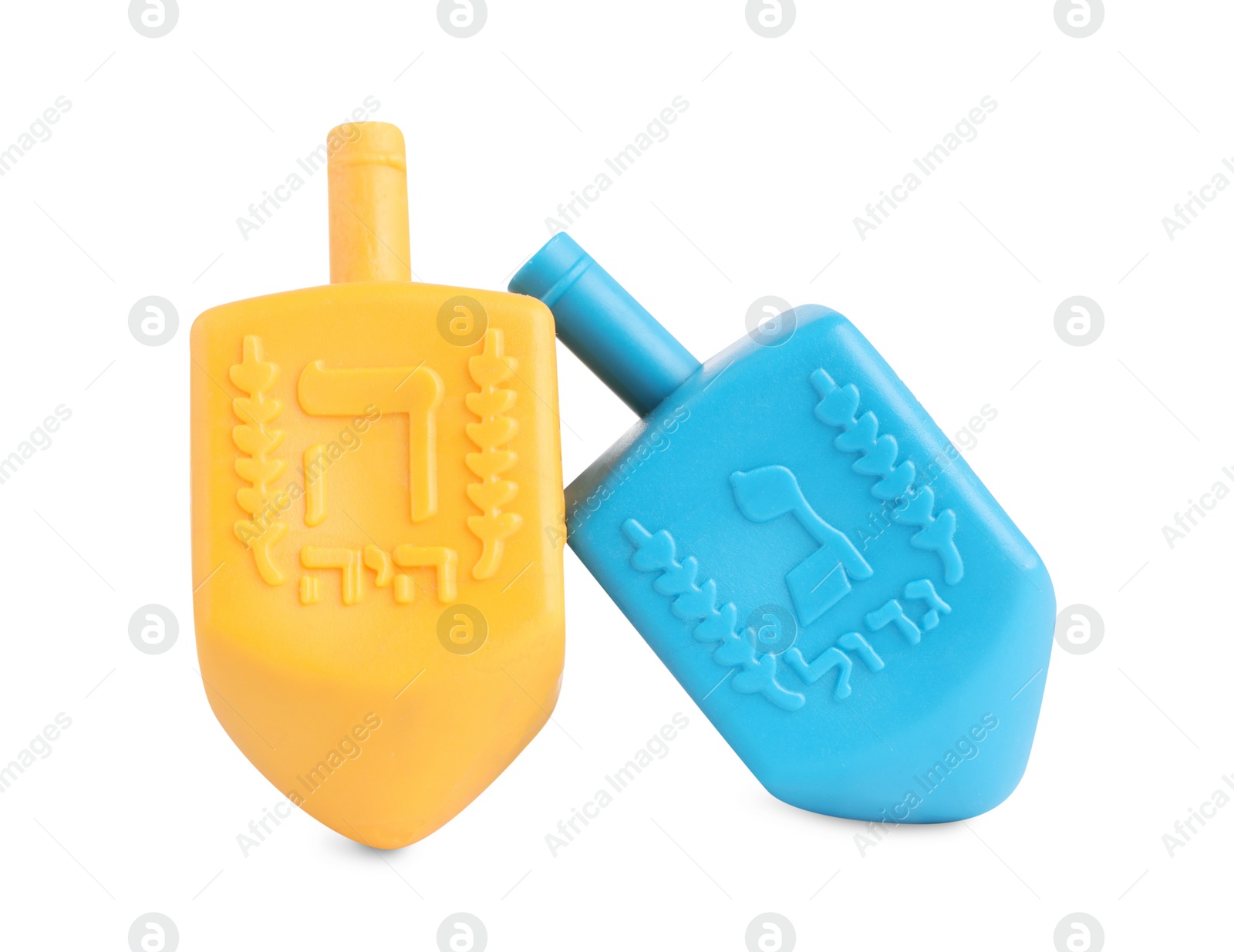 Photo of Hanukkah celebration. Colorful dreidels with jewish letters isolated on white