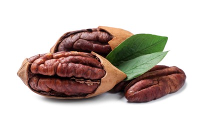 Photo of Many tasty pecan nuts with green leaves isolated on white