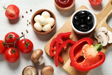 Photo of Flat lay composition with fresh ingredients for pizza on white wooden table