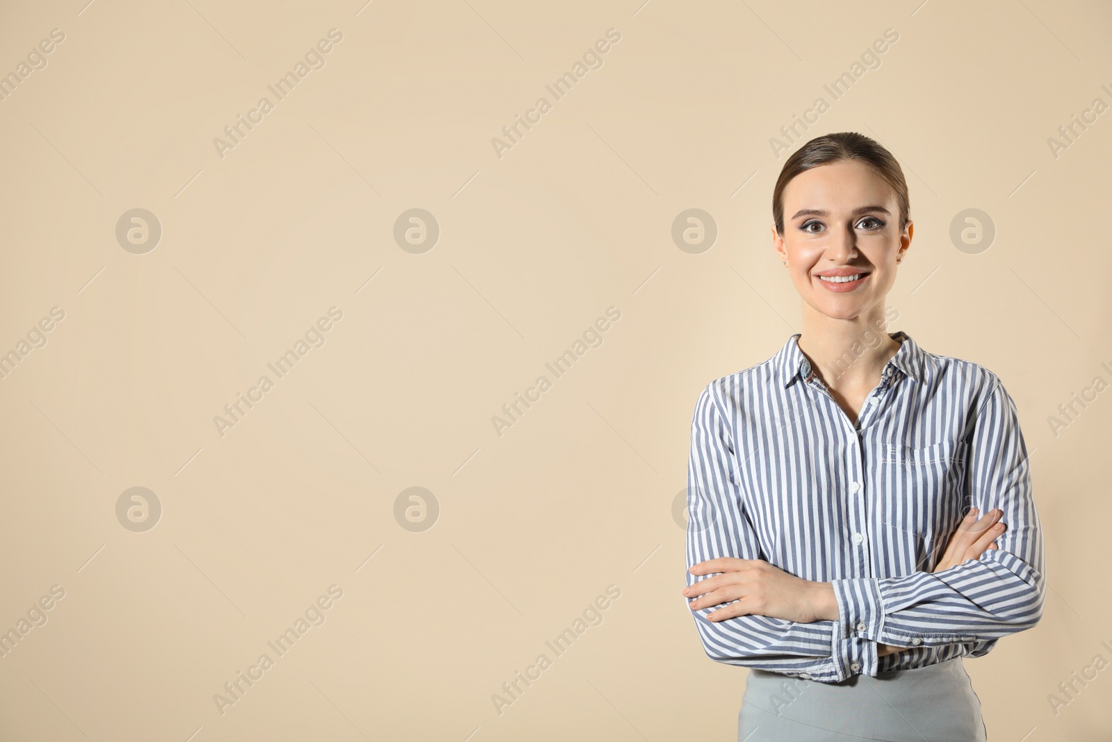 Photo of Portrait of young female teacher on beige background. Space for text