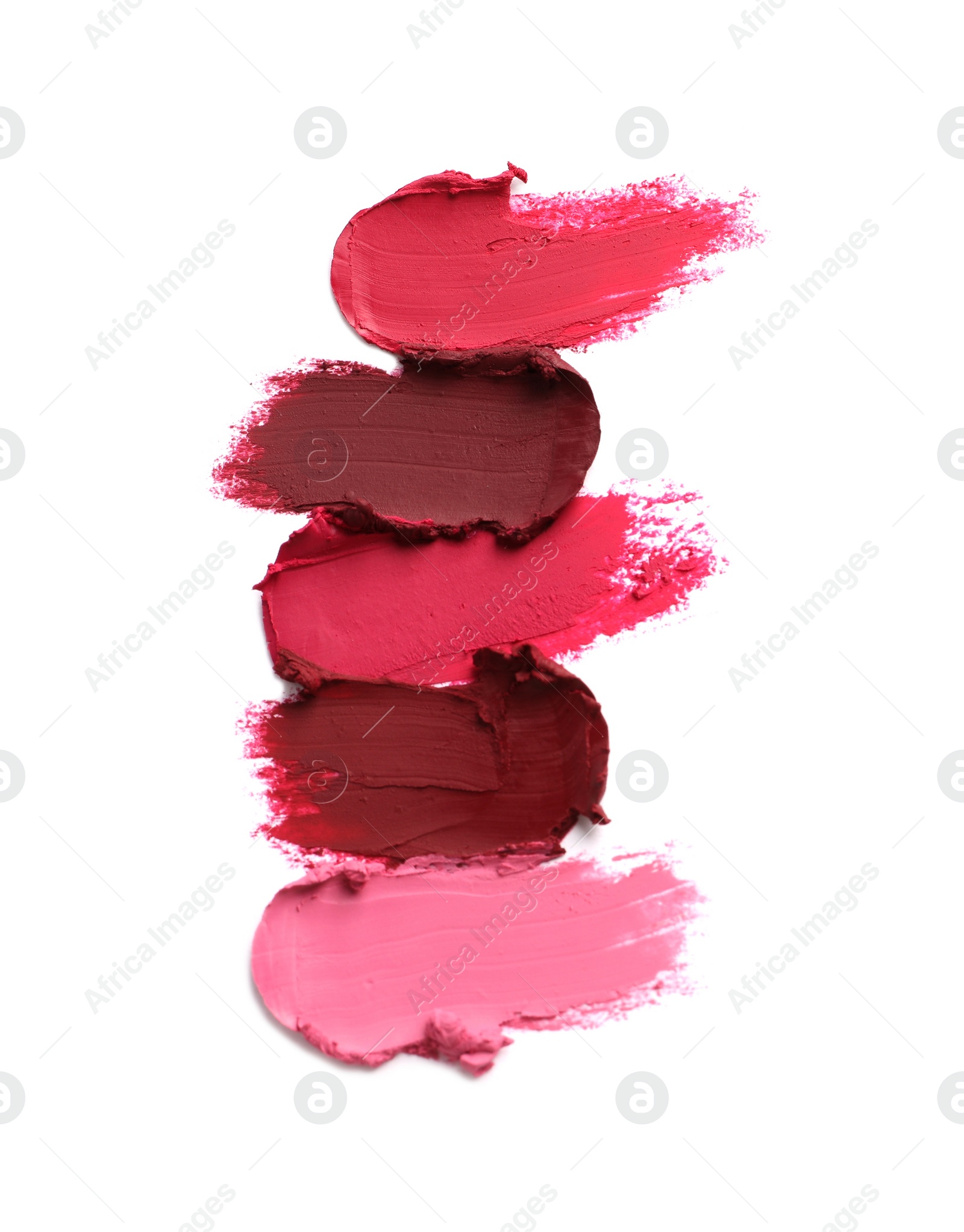 Photo of Smears of bright lipsticks on white background, top view