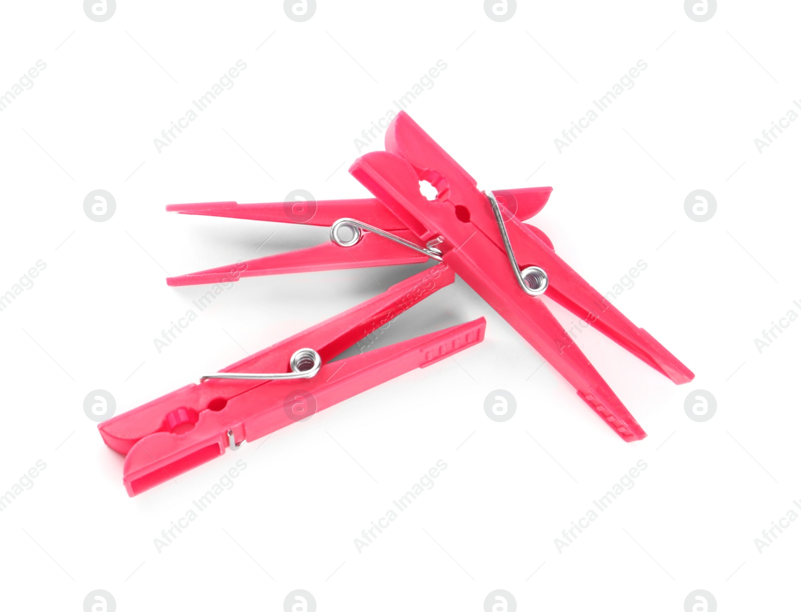 Photo of Bright pink plastic clothespins on white background, above view