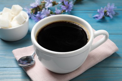 Photo of Cup of delicious chicory drink on turquoise wooden table, closeup