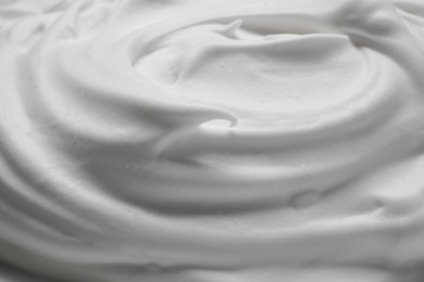 Photo of Texture of white shaving foam as background, closeup