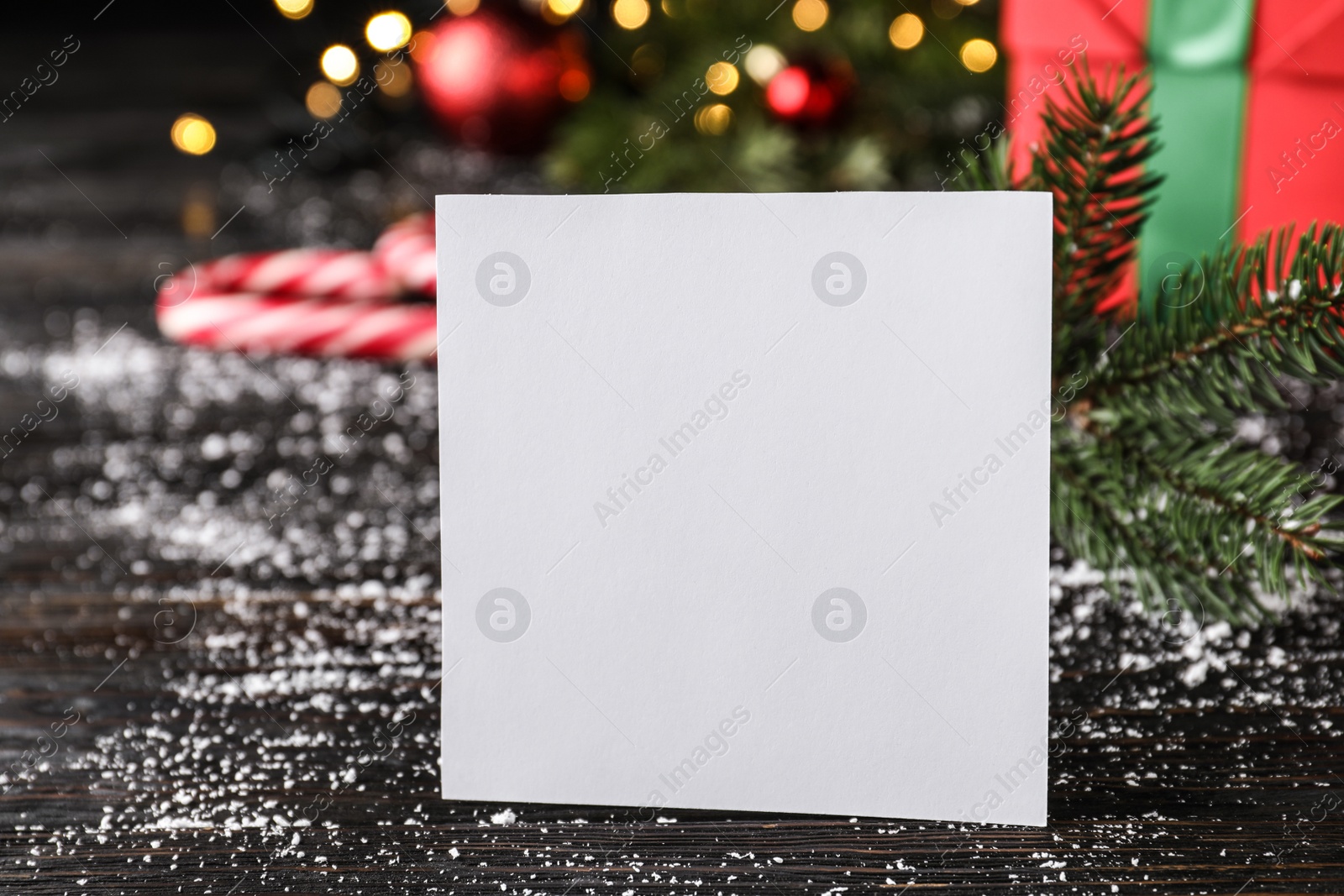 Photo of Blank Christmas card on wooden table, closeup. Space for text