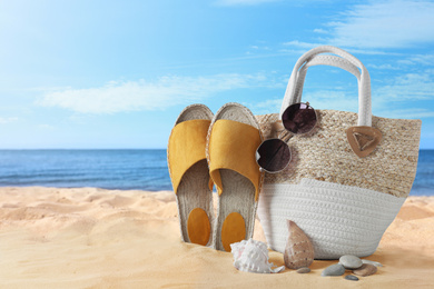 Image of Beach objects on sand near sea, space for text. Summer vacation 