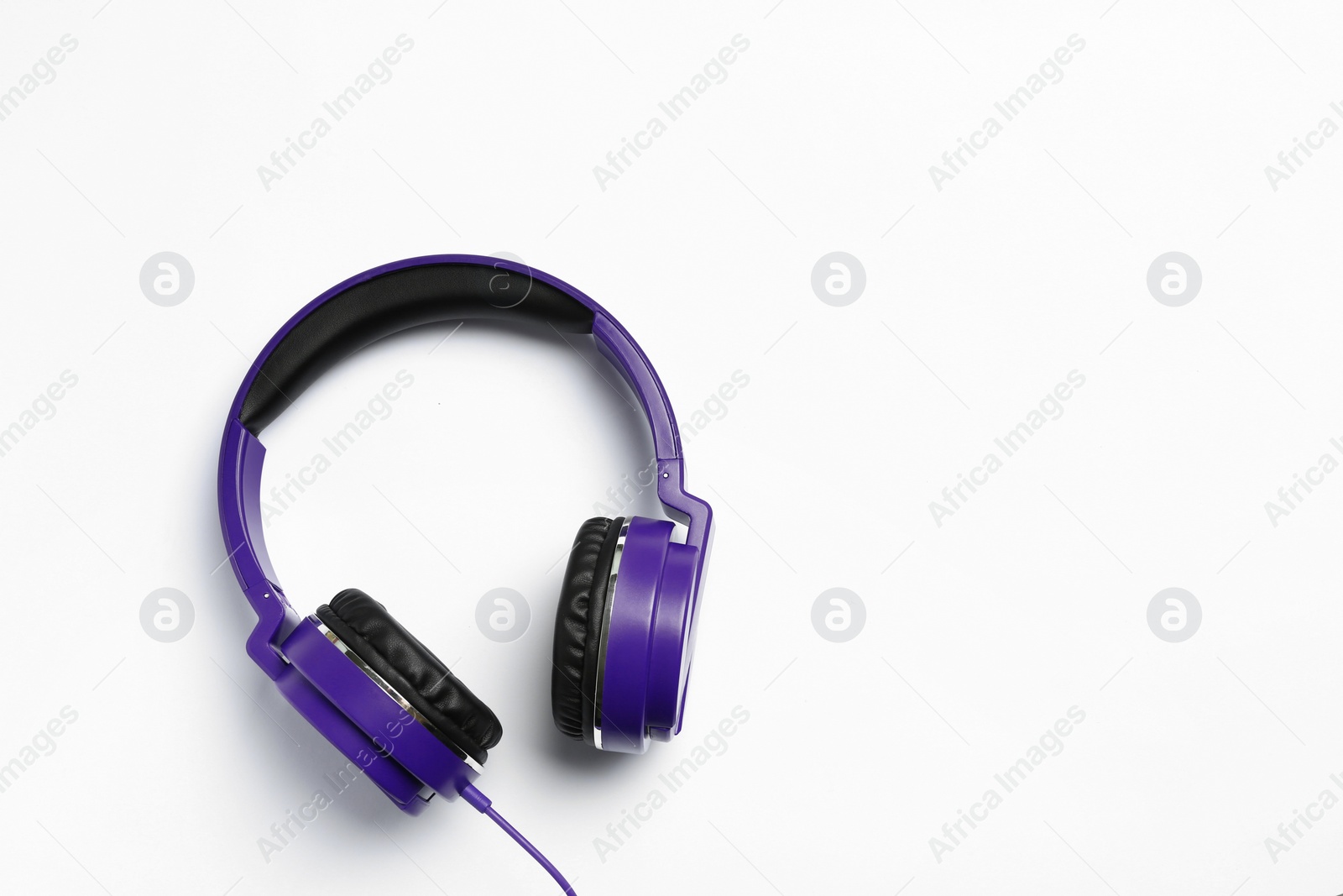 Photo of Stylish modern headphones on white background, top view