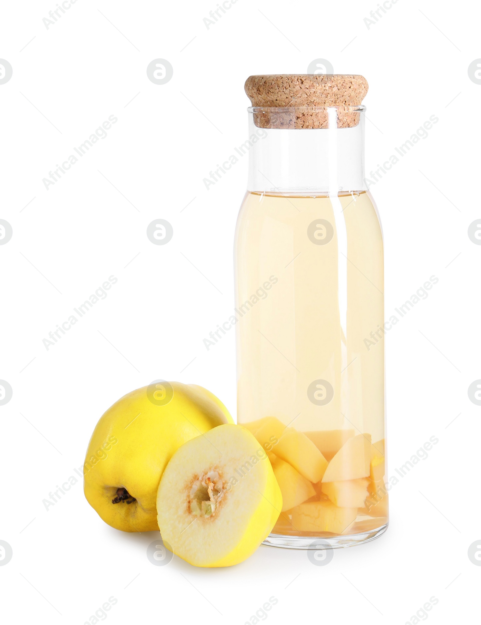 Photo of Tasty quince drink in glass carafe and fresh cut fruits isolated on white