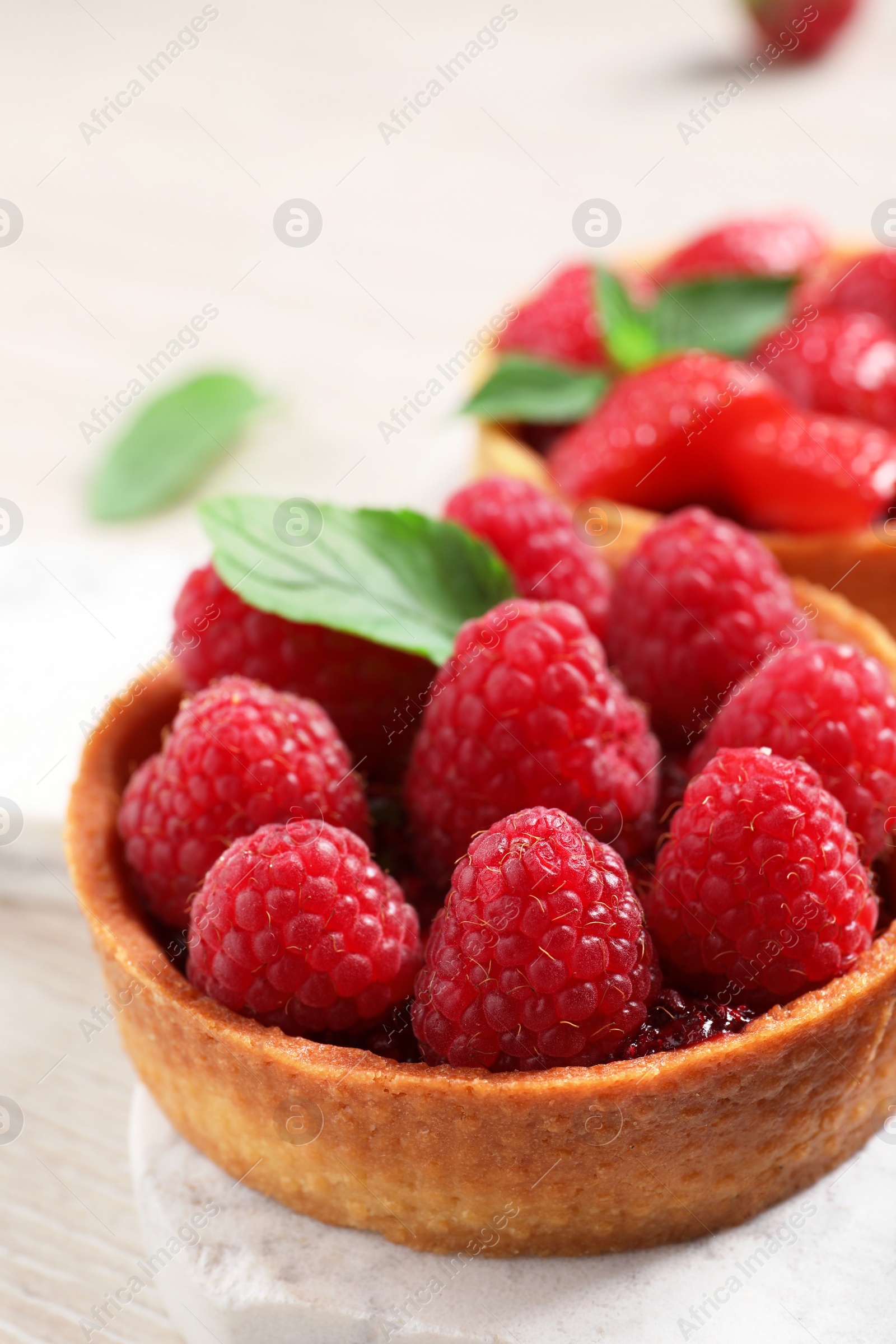 Photo of Tartlet with fresh raspberries on table, closeup and space for text. Delicious dessert