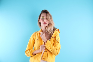 Beautiful young woman posing on color background. Summer fashion